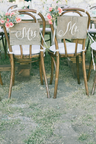 wooden chair with Mr & Mrs signage and flowers