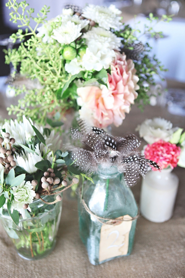 pretty bottle and feather centerpieces